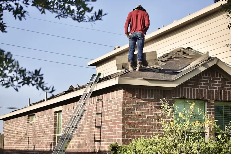 Professional roofer working on a residential roof in Sand Ridge